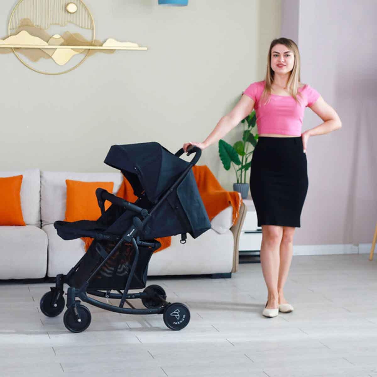 عربة أطفال تيكنوم سوداء مع كرسي هزاز وحقيبة حمل حفاضات وردية أنيقة للأطفال الصغار، من عمر 0 إلى سنتين